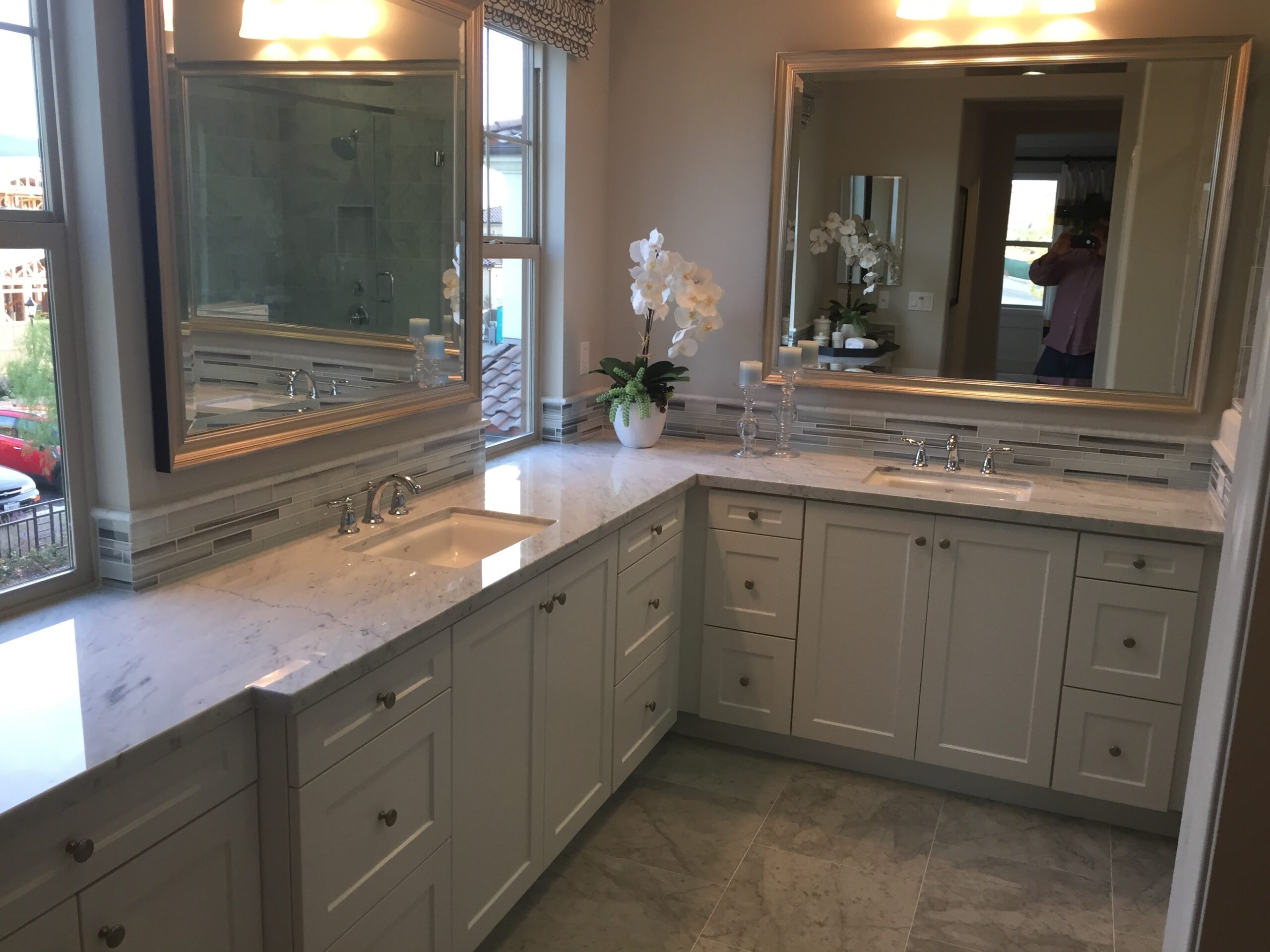 Contractor reviewing Kitchen Remodeling plans in Escondido - CA inside a bright home with sample finishes